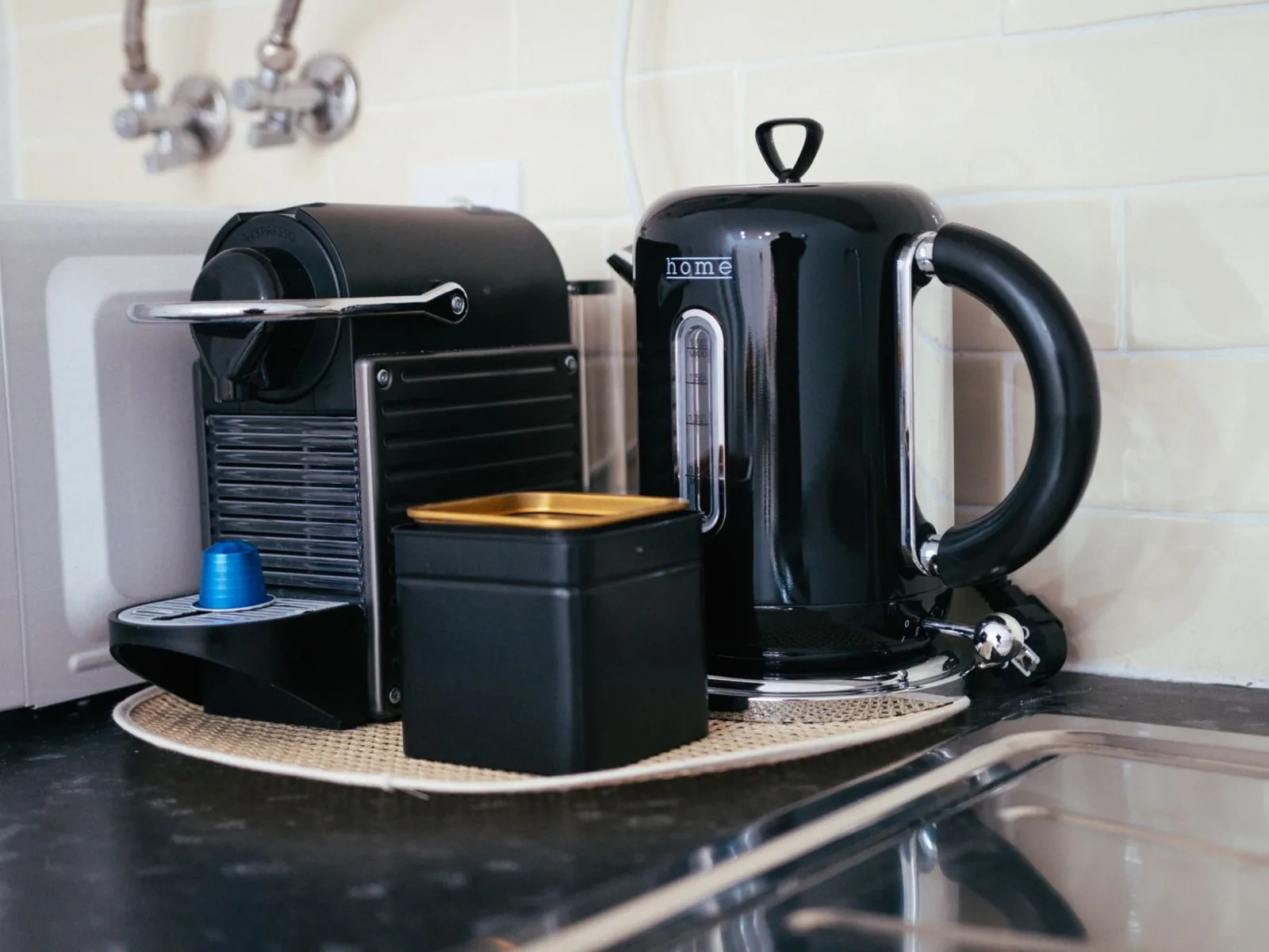 Electric kettle and coffee machine on a kitchen counter
